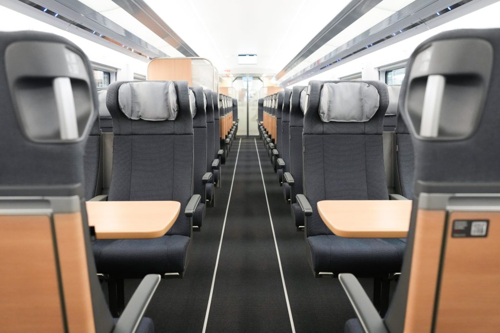 the new DB interior with modern grey upholstery on the chairs and wooden accents